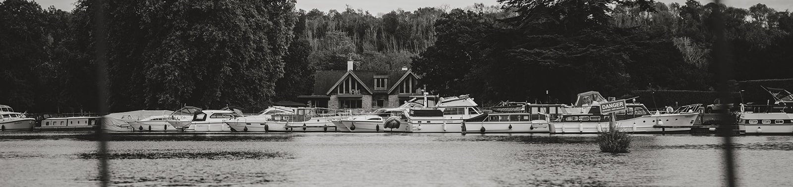 Boats moored at a riverside marina on the Thames, seen from aboard
